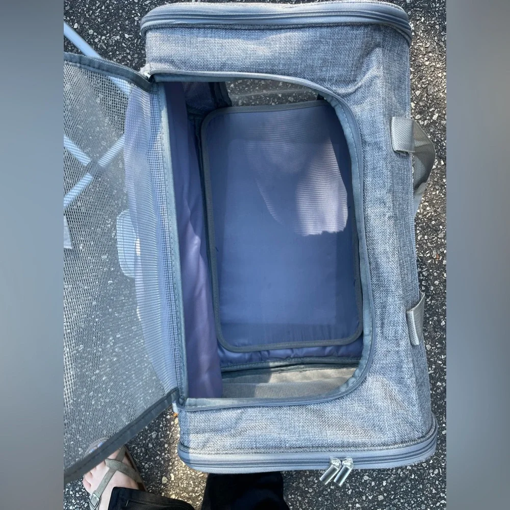 A pet travel carrier and roller. 2 doors on each side. Detachable roller base.